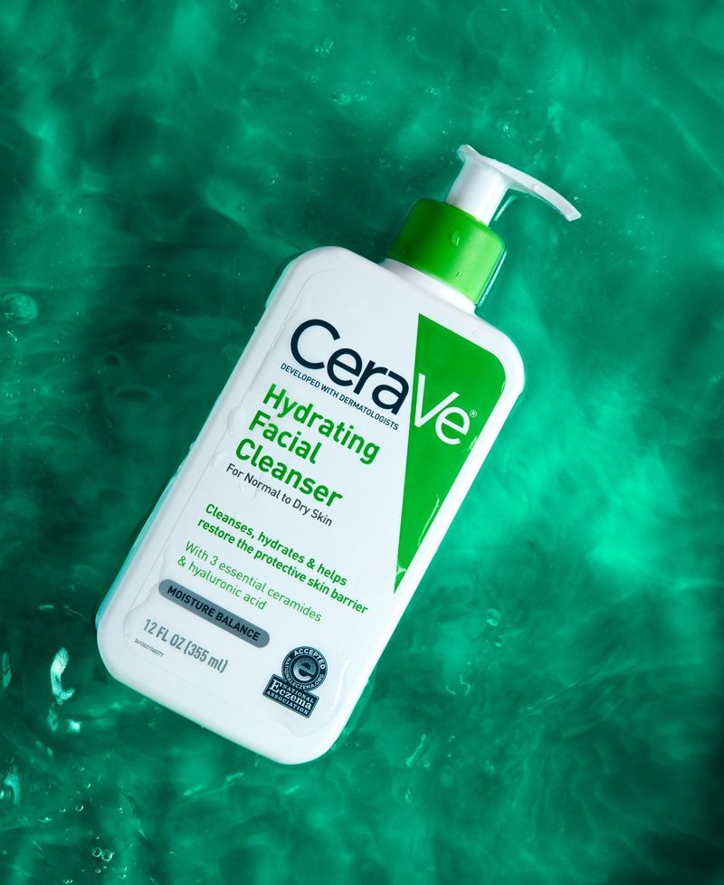 CeraVe hydrating facial cleanser bottle on a green water background