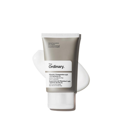 The Ordinary Vitamin C Suspension 23% + Hyaluronic Acid Spheres 2% serum tube with product texture displayed in the background, a high-strength Vitamin C treatment designed to brighten skin, reduce dark spots, and improve overall skin radiance.