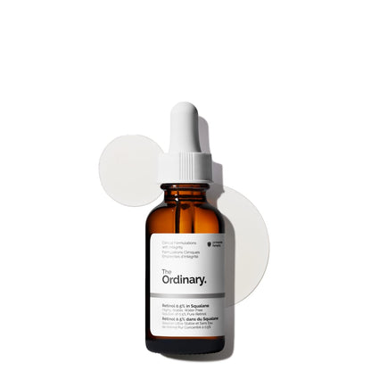 The Ordinary Retinol 0.5% in Squalane anti-aging serum in an amber glass dropper bottle displayed with translucent serum texture swatches. A medium-strength retinol formula designed to help reduce fine lines, improve skin texture, support skin renewal, and provide hydration with squalane.