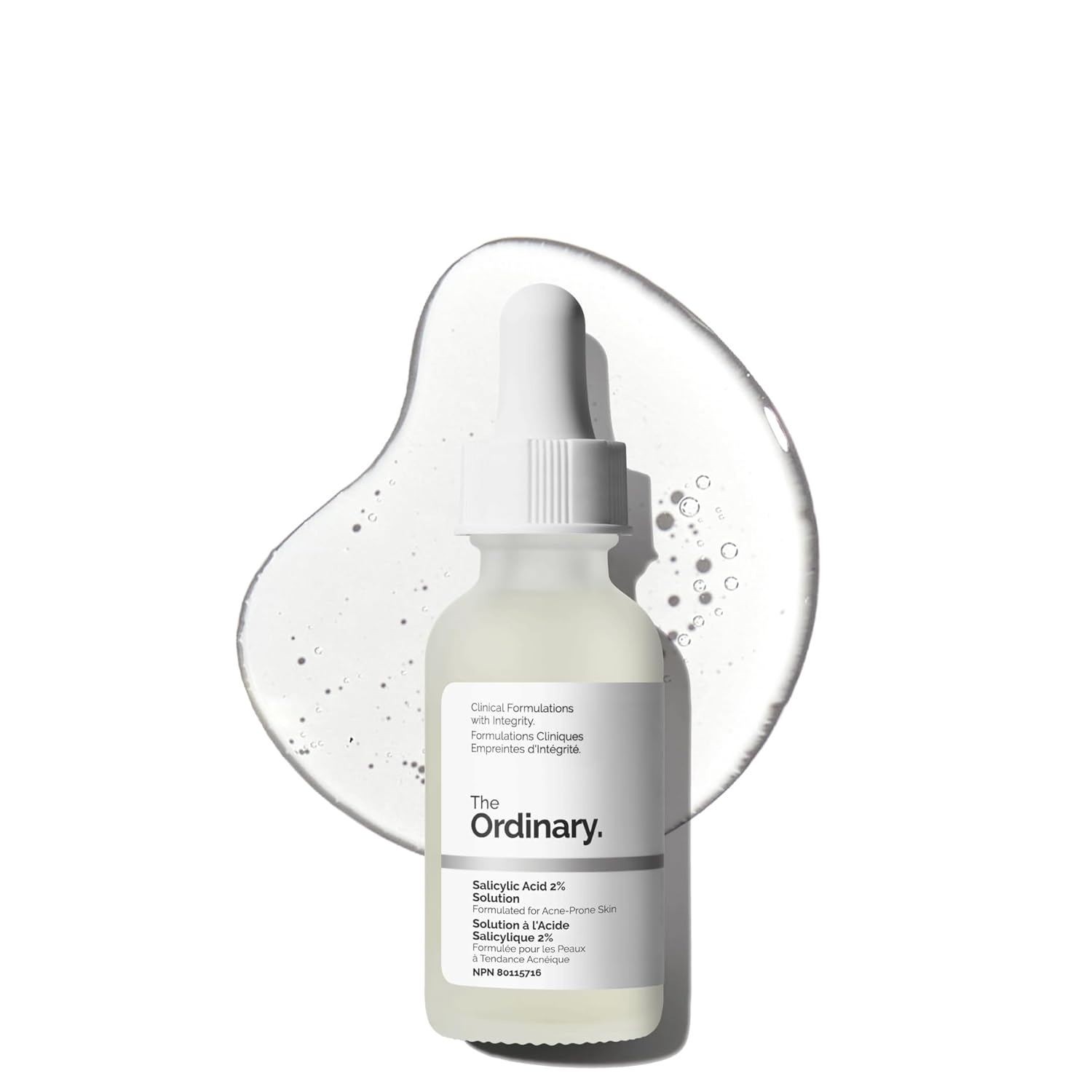 The Ordinary Salicylic Acid 2% Solution serum bottle displayed in front of a clear serum texture backdrop. Acne-fighting exfoliating serum formulated for blemish-prone skin, clogged pores, blackheads, and breakouts.