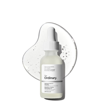 The Ordinary Salicylic Acid 2% Solution serum bottle displayed in front of a clear serum texture backdrop. Acne-fighting exfoliating serum formulated for blemish-prone skin, clogged pores, blackheads, and breakouts.