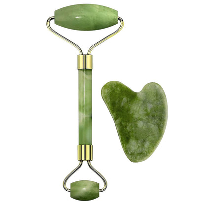Green jade roller and gua sha tool on a white background