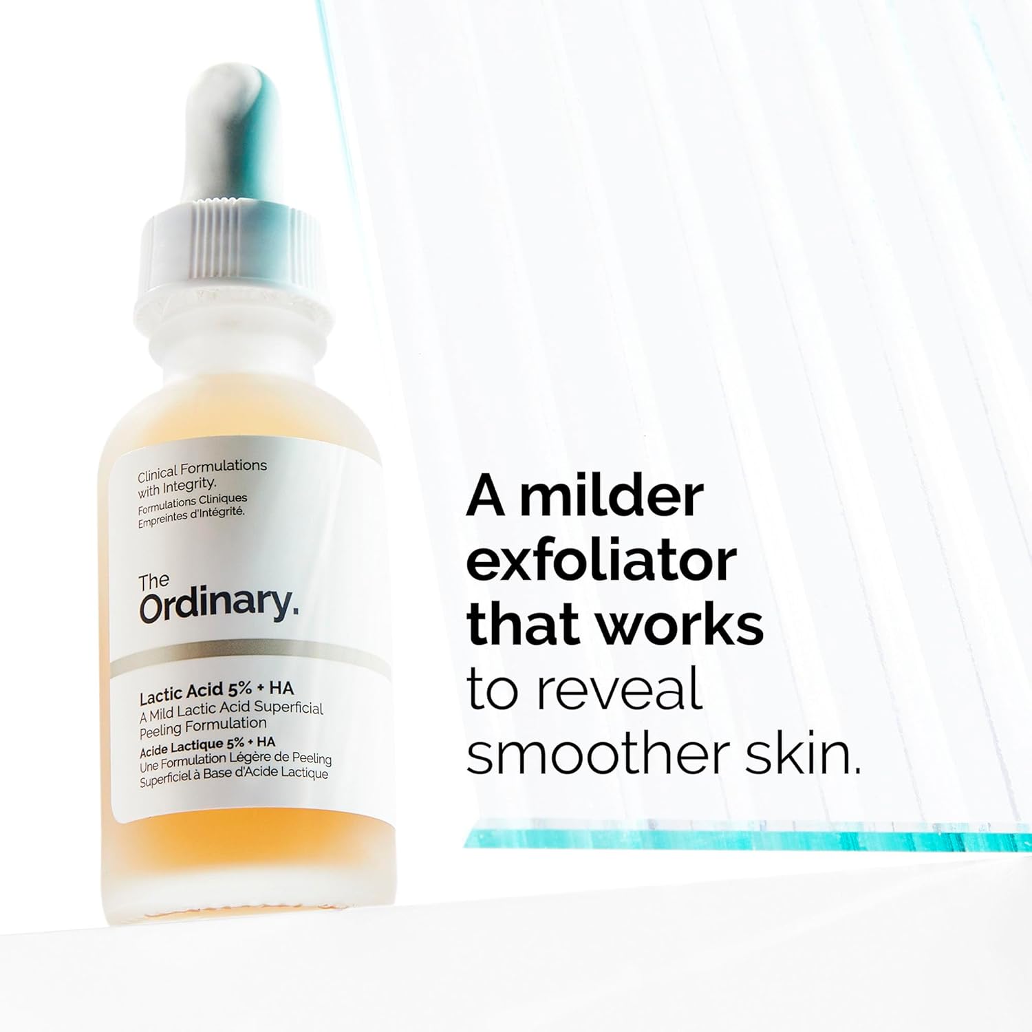Promotional image of The Ordinary Lactic Acid 5% + HA serum in a frosted dropper bottle. The graphic highlights the product as a milder exfoliator that helps reveal smoother-looking skin. Designed with lactic acid and hyaluronic acid to gently exfoliate, improve skin texture, and maintain hydration for a softer, more radiant complexion.