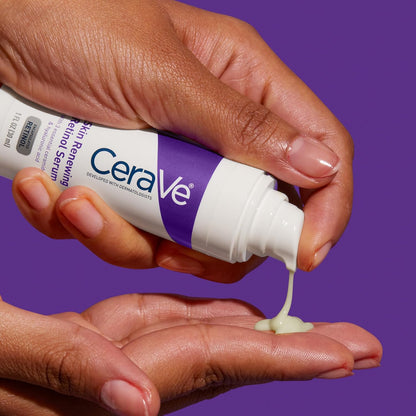 CeraVe skincare product being applied to a hand against a purple background