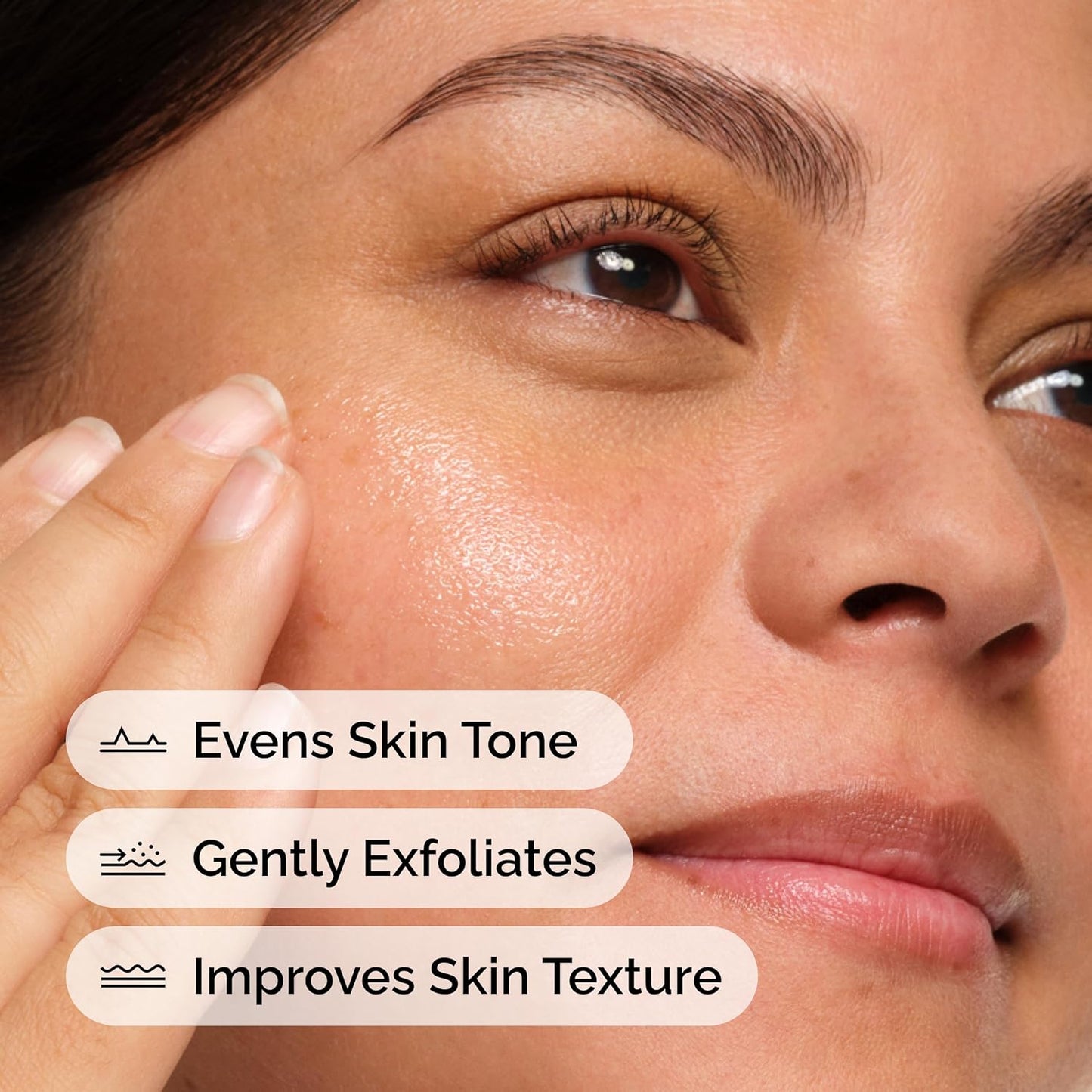 Close-up of a model with glowing, healthy-looking skin demonstrating the benefits of The Ordinary Mandelic Acid 10% + HA serum. The image highlights key benefits including evening skin tone, gentle exfoliation, and improving skin texture for a smoother, more radiant complexion. Suitable for those seeking brighter, clearer-looking skin with a gentle exfoliating serum.