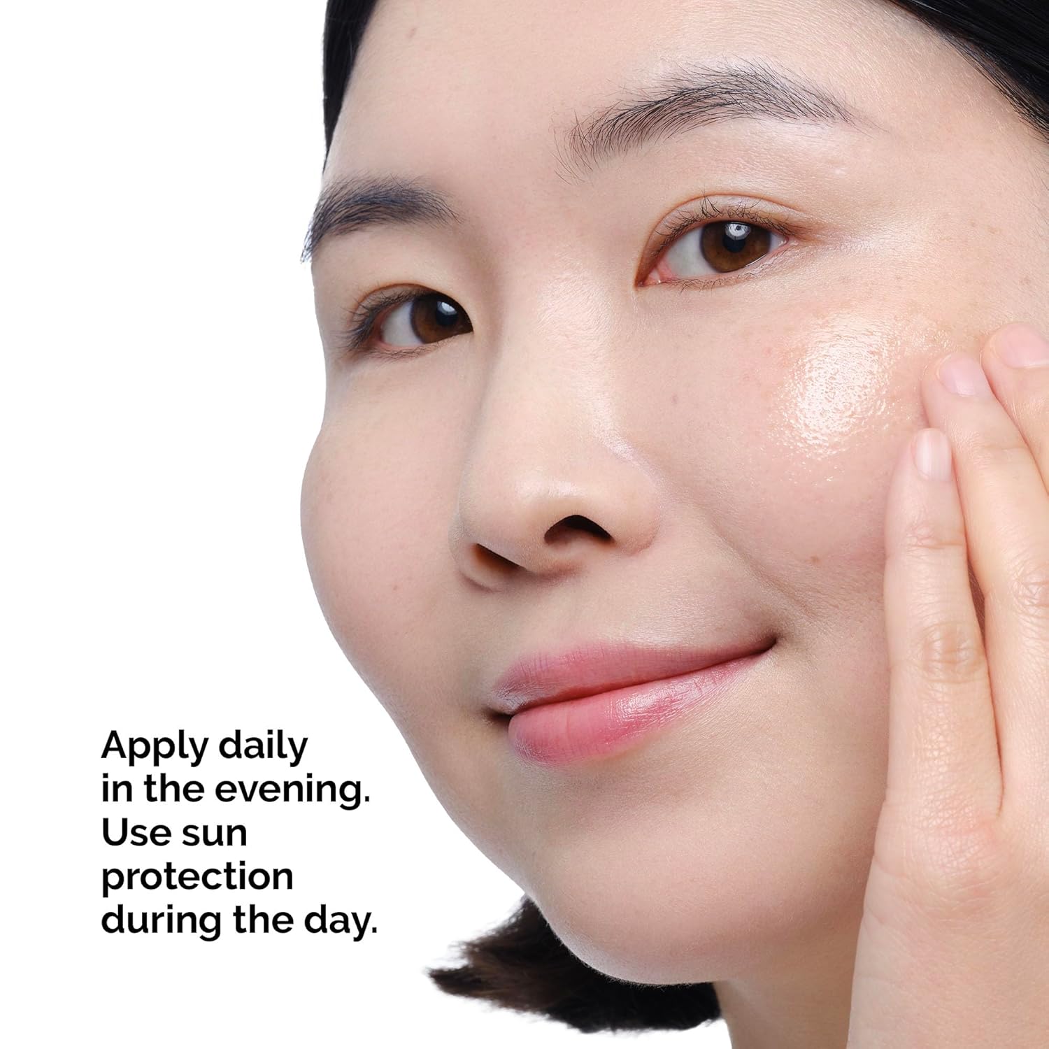 Close-up of a woman with smooth, glowing skin gently touching her cheek, demonstrating the use of The Ordinary Retinol 0.2% in Squalane. The image highlights application instructions: apply daily in the evening and use sun protection during the day. Suitable for beginners looking to improve skin texture, hydration, and visible signs of aging.