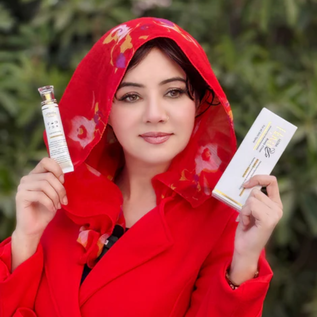 Woman in a red outfit holding skincare products against a blurred green background