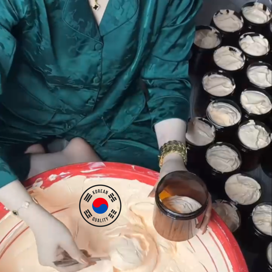 Person in a teal outfit with a bowl of white cream and a tray of black containers with white substance.