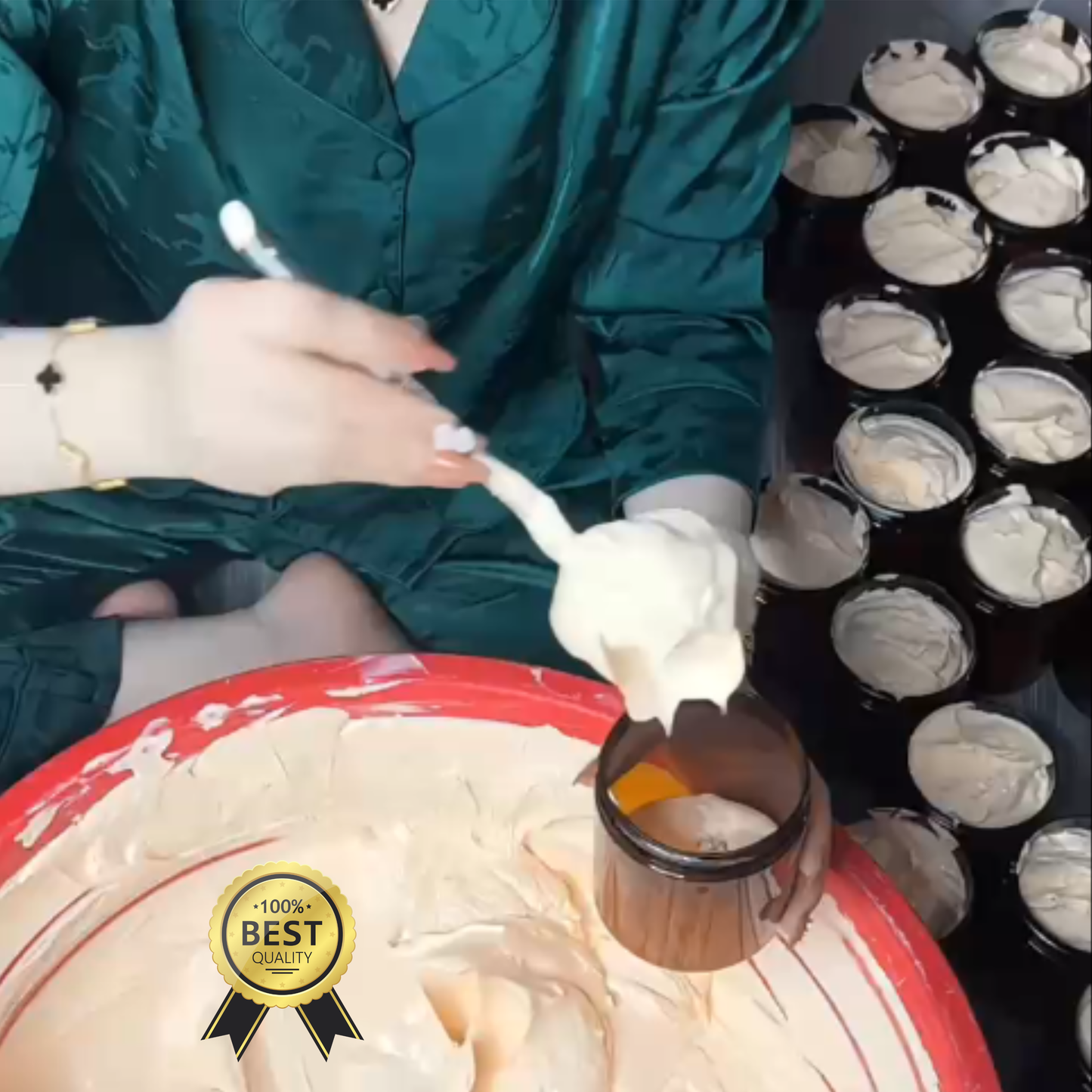 Person filling small containers with white cream, surrounded by more containers and a large bowl of cream.