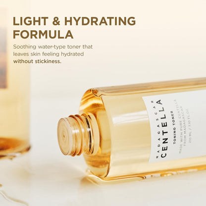 Close-up promotional image of SKIN1004 Madagascar Centella Toning Toner 210ml highlighting its lightweight, water-based formula. The toner bottle is shown lying on its side with golden toner visible inside, emphasizing a refreshing texture that hydrates and soothes the skin without leaving a sticky residue. Enriched with Madagascar Centella Asiatica to calm irritation, replenish moisture, and support a healthy skin barrier. Suitable for all skin types, including sensitive skin.