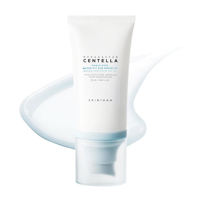 SKIN1004 Madagascar Centella Hyalu-Cica Water-Fit Sun Serum UV SPF 50+ PA++++ in a 50ml tube with a lightweight serum texture displayed behind the product. Hydrating Korean sunscreen with Centella Asiatica and Hyaluronic Acid that provides broad-spectrum UV protection, leaves no white cast, and offers a smooth, non-greasy finish for daily use.