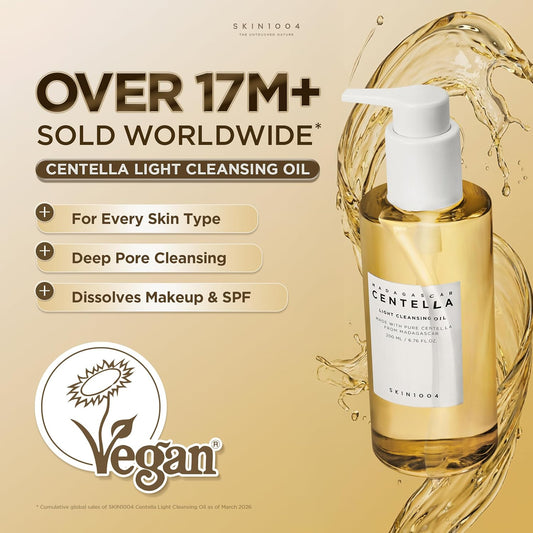Promotional image featuring SKIN1004 Madagascar Centella Light Cleansing Oil 200ml with a golden oil splash background. Highlights key benefits including suitability for all skin types, deep pore cleansing, and effective removal of makeup and sunscreen. The product is labeled vegan and showcases its lightweight Korean cleansing oil formula designed for daily double cleansing and pore care.