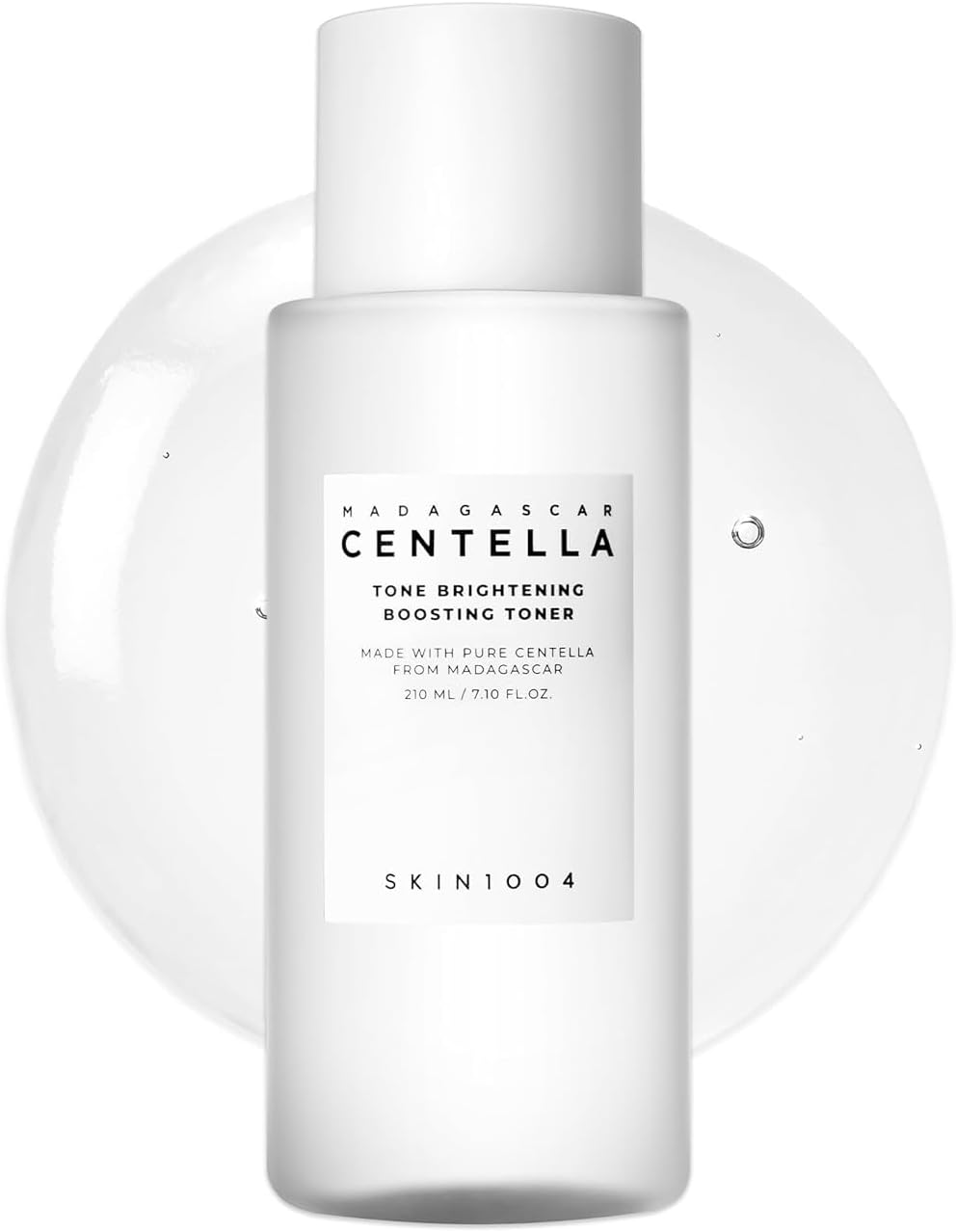 Front product image of SKIN1004 Madagascar Centella Tone Brightening Boosting Toner 210ml. The brightening toner is displayed in a sleek white bottle against a clear toner texture background. Formulated with Madagascar Centella Asiatica, Niacinamide, and MadeWhite™ to help brighten dull skin, improve uneven skin tone, provide gentle exfoliation, and enhance skin radiance. Lightweight, hydrating formula suitable for all skin types, including sensitive skin.