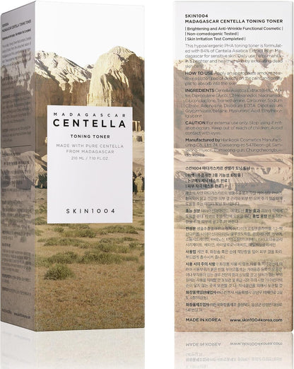 Front and back packaging view of SKIN1004 Madagascar Centella Toning Toner 210ml. The box features a Madagascar-inspired landscape design and detailed product information, including ingredients, usage instructions, and skincare benefits. Formulated with 84% Madagascar Centella Asiatica Extract, PHA, and Hyaluronic Acid to gently exfoliate, soothe irritation, hydrate the skin, and improve skin texture. Suitable for sensitive skin and designed to support a healthy, balanced complexion.