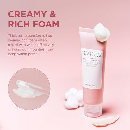 Promotional image of SKIN1004 Madagascar Centella Poremizing Deep Cleansing Foam showcasing its creamy and rich foam texture. The pink cleanser tube is displayed with soft foam accents, highlighting how the thick paste transforms into a dense, creamy lather when mixed with water. Designed to help draw out impurities from deep within pores while providing a thorough yet gentle cleanse.