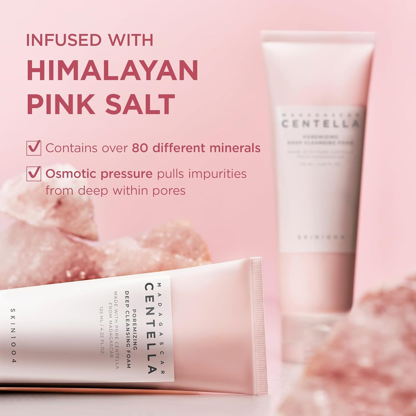 Promotional image of SKIN1004 Madagascar Centella Poremizing Deep Cleansing Foam highlighting Himalayan Pink Salt as a key ingredient. The image features two pink cleanser tubes surrounded by pink salt crystals and notes that the formula contains over 80 different minerals. It emphasizes osmotic pressure technology that helps draw impurities from deep within pores for a thorough cleanse, leaving skin refreshed and purified.