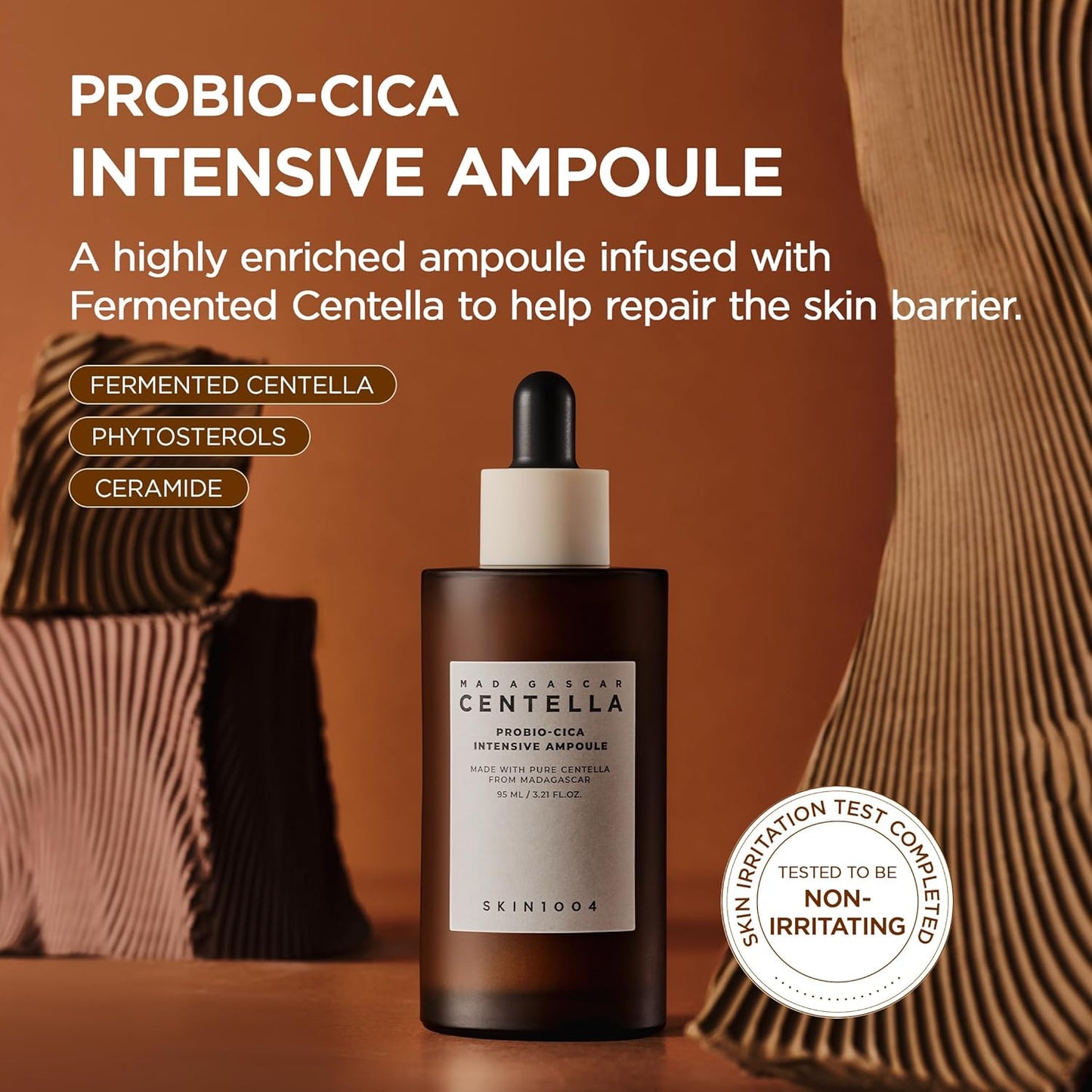 Promotional image of SKIN1004 Madagascar Centella Probio-Cica Intensive Ampoule featuring a 95ml amber dropper bottle. Highlights fermented Centella, phytosterols, and ceramides to help repair the skin barrier, nourish sensitive skin, and provide intensive hydration. Includes non-irritating skin test certification and Korean skincare benefits.