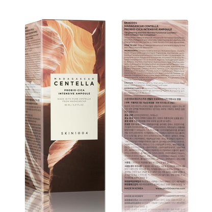 Front and back view of the SKIN1004 Madagascar Centella Probio-Cica Intensive Ampoule 95ml product box. The packaging features a canyon-inspired design and includes detailed product information, ingredients, usage directions, benefits, and manufacturer details. Highlights the nourishing ampoule formulated with fermented Centella Asiatica, ceramides, and skin barrier-supporting ingredients for soothing, strengthening, and revitalizing sensitive skin.