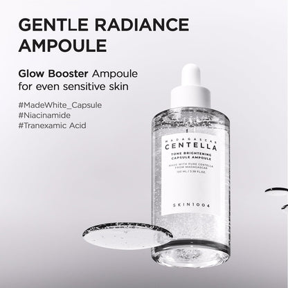 Promotional image of SKIN1004 Madagascar Centella Tone Brightening Capsule Ampoule 100ml featuring Niacinamide, Tranexamic Acid, and MadeWhite™ capsules. Highlights gentle radiance, glow-boosting benefits, and suitability for sensitive skin. The serum bottle with visible brightening capsules is displayed on a clean white background with a glossy serum texture swatch.