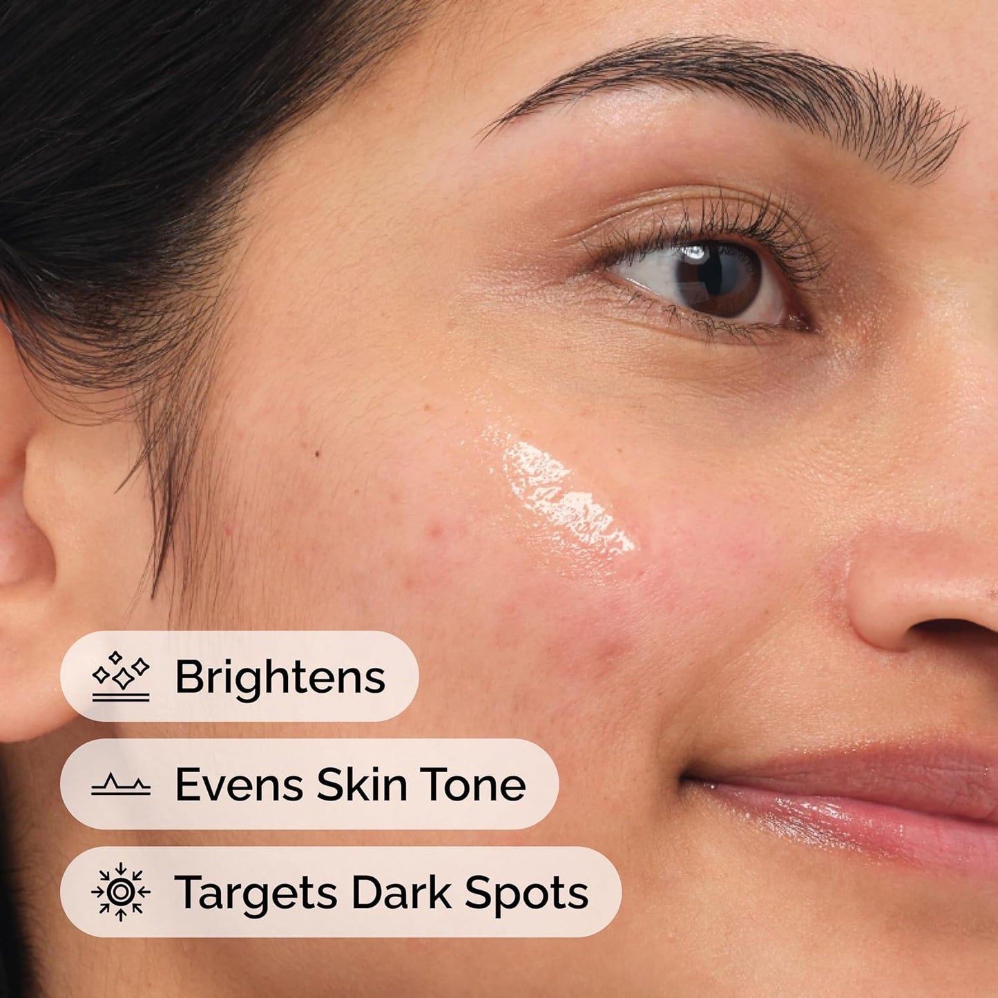 Close-up of a model applying The Ordinary Alpha Arbutin 2% + Hyaluronic Acid serum to the face, highlighting its key benefits of brightening the complexion, evening skin tone, and targeting the appearance of dark spots for a more radiant, even-looking complexion.