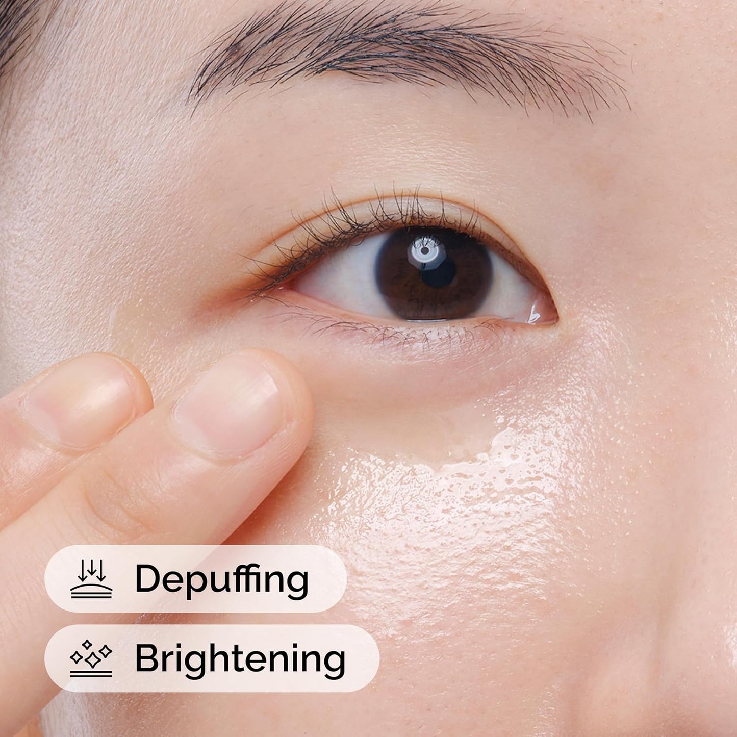 Close-up of a model applying The Ordinary Caffeine Solution 5% + EGCG under the eye area. The image highlights the serum’s depuffing and brightening benefits, showing a hydrated, refreshed-looking under-eye area with a smooth, radiant appearance.
