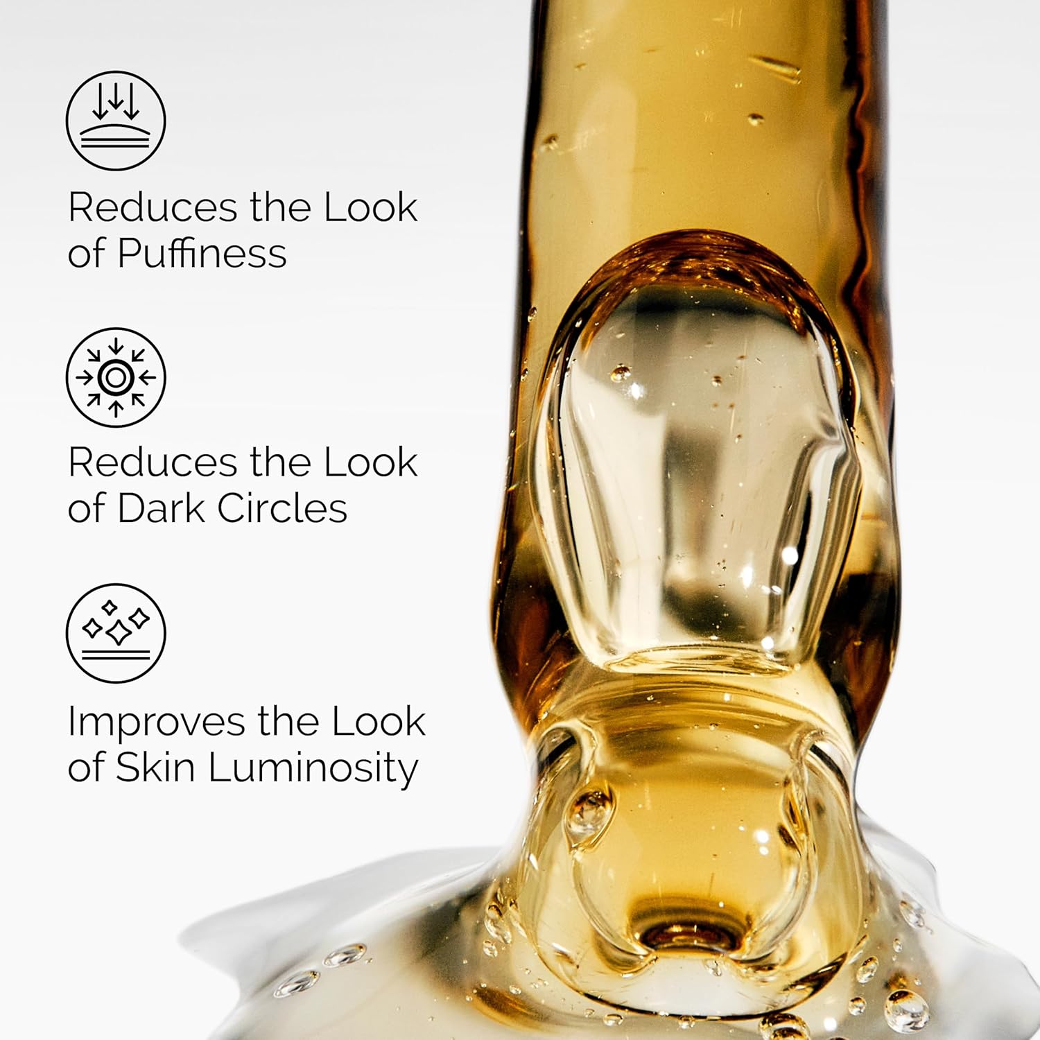 Close-up image of a golden serum texture highlighting the key benefits of The Ordinary Caffeine Solution 5% + EGCG eye serum. The graphic emphasizes reducing the appearance of puffiness, minimizing the look of dark circles, and improving overall skin luminosity around the eye area. The lightweight formula is shown in a glossy, concentrated serum texture.