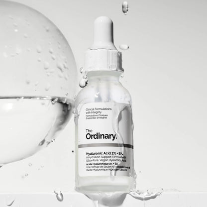 Skincare serum bottle labeled 'The Ordinary' with dropper on a light gray background