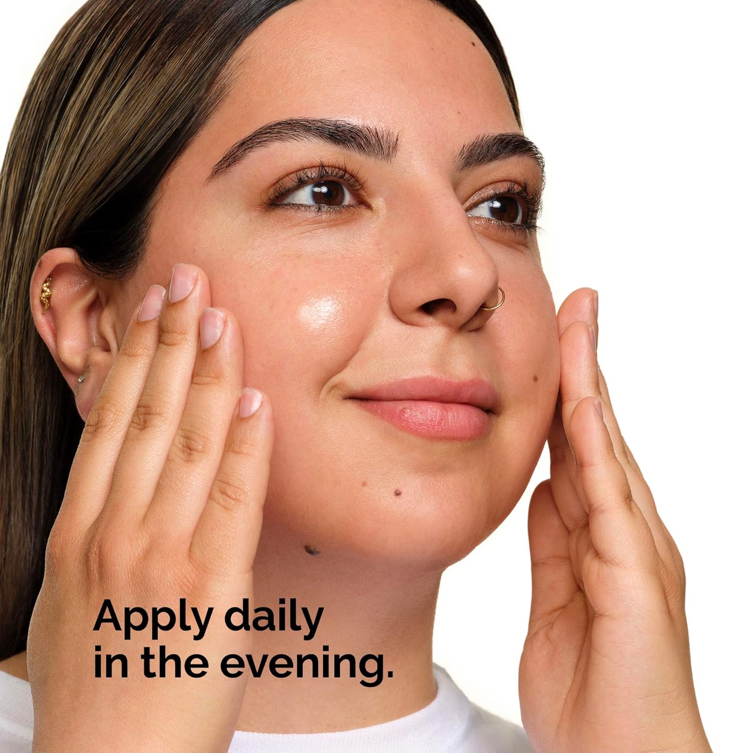 Lifestyle image showing a person applying The Ordinary Lactic Acid 10% + HA serum to the face. Demonstrates proper evening skincare application and highlights the serum’s use in a nighttime routine to exfoliate, smooth skin texture, and promote a brighter, more radiant complexion.